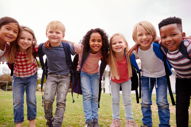Portrait Of Excited Elementary School Pupils On Playing Field At Break Time Portrait Of Excited Elementary School Pupils On Playing Field At Break Time school kids stock pictures, royalty-free photos & images